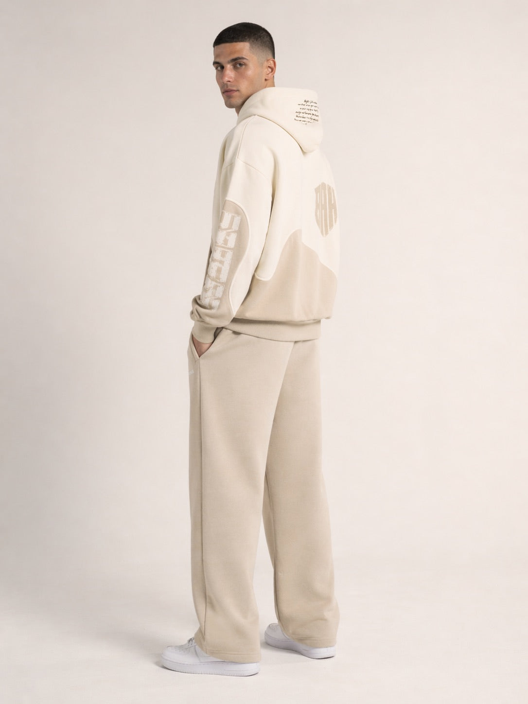 Beiger Oversized Hoodie 3/4-Seitenansicht am Model, Wappen-Print Rücken, Sleeve-Print, Streetwear